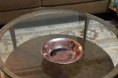 Rust-red bowl. Wide bowl with throwing rings showing through a red-brown glaze.