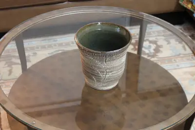 Textured series: green-lined cup. Textured cup with a dark green glazed interior.