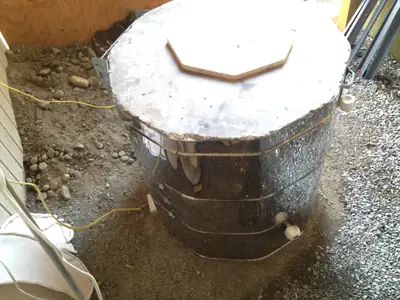 On its pad. The kiln set on its foundation.